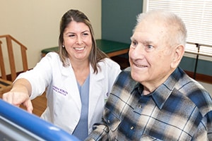 The rehab therapist with a resident in the gym