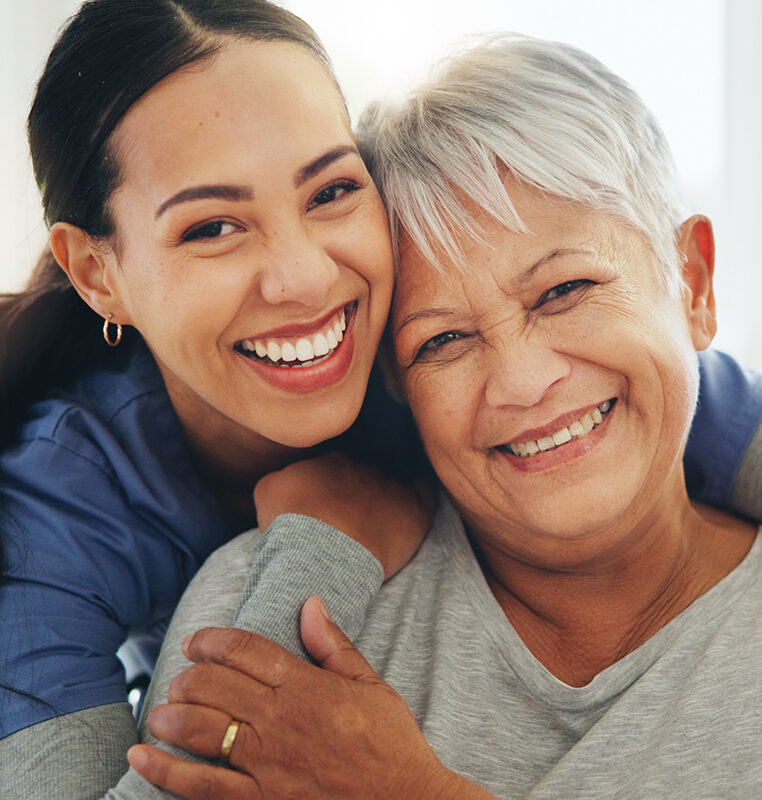 Happy woman, nurse and hug senior patient in elderly care, support or trust at old age home. Portrait of mature female person, doctor or medical caregiver hugging with smile for embrace at house