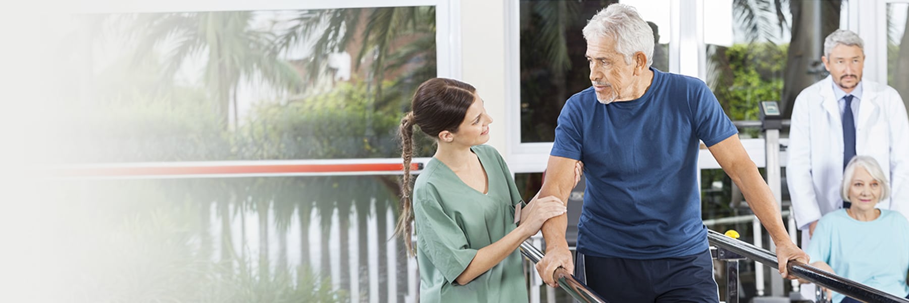 nurse walking with man using a walker
